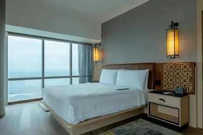 a bedroom with a large bed and a large window at JW Marriott Hotel Lima in Lima