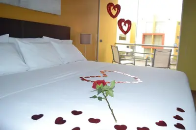 a bed with a flower on it with hearts on it at Kajaca Suite Hotel in Huacho