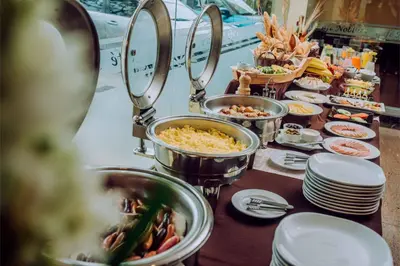 a buffet with many dishes of food on a table at Hotel Nobility in Lima