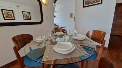 a dining room with a glass table and chairs at MALECÓN BALTA 758 - Miraflores in Lima