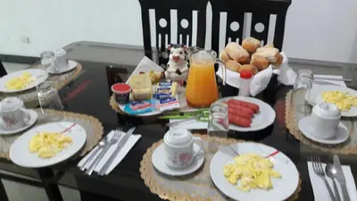 a table with plates of breakfast food on it at B&B La Casa del Turista in Lima