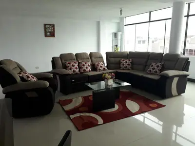 a living room with a couch and a coffee table at B&B La Casa del Turista in Lima