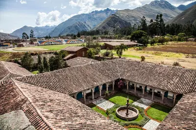an aerial view of a house with mountains in the background at San Agustin Monasterio de la Recoleta in Urubamba
