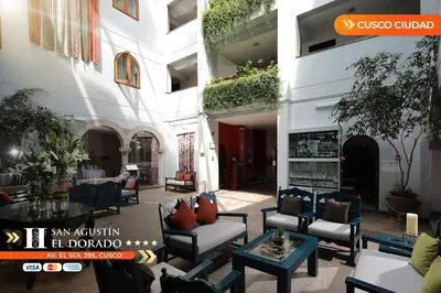 a courtyard with chairs and tables in a building at San Agustin El Dorado in Cusco