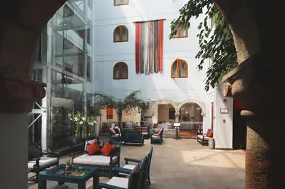 a lobby of a building with couches and tables at San Agustin El Dorado in Cusco