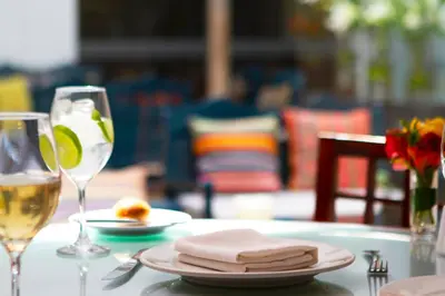a table with a plate of food and a glass of wine at San Agustin El Dorado in Cusco