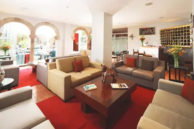 a living room with couches and a coffee table at San Agustin El Dorado in Cusco