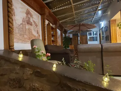 a living room with couches and a table with lights at Hotel Sueños del Inka in Cusco
