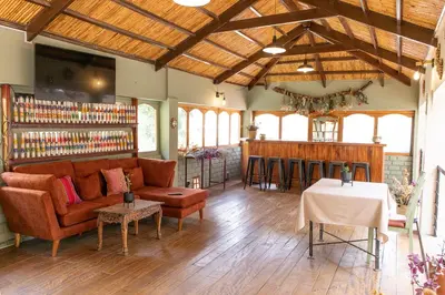 a living room with a couch and a bar at Tariq Sacred Valley in Urubamba