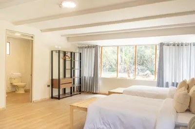 a bedroom with two beds and a window at Tariq Sacred Valley in Urubamba