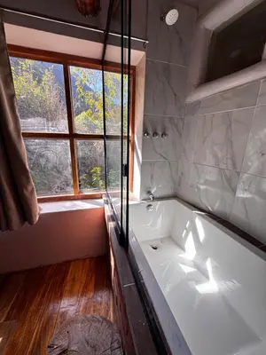 a bath tub in a bathroom with a window at Casa de campo Yoga Retreat in Urubamba