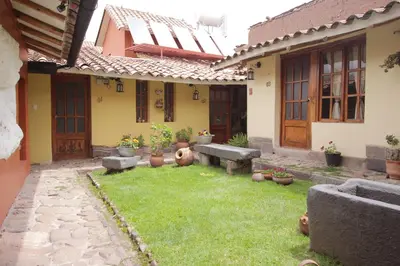 a yard with a bench in front of a house at 