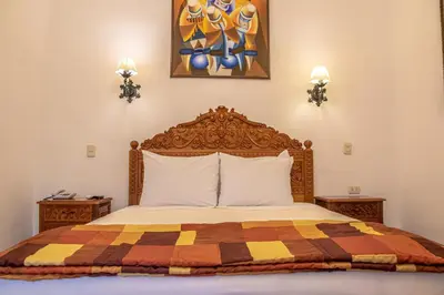 a bedroom with a bed with a colorful quilt at Amaru Inca in Cusco