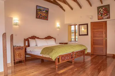 a bedroom with a bed and a wooden floor at Amaru Inca in Cusco