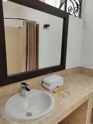 a bathroom with a sink and a mirror at Hosteria de Anita in Cusco