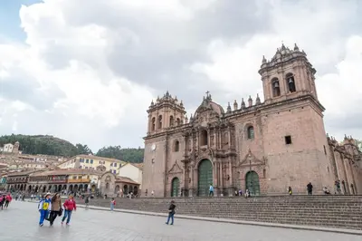 a large cathedral with people walking in front of it at Hosteria de Anita in Cusco