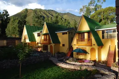 a house with a mountain in the background at Amaru Valle Hotel in Urubamba