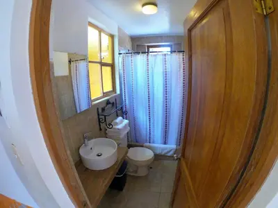 a small bathroom with a toilet and a sink at Amaru Valle Hotel in Urubamba