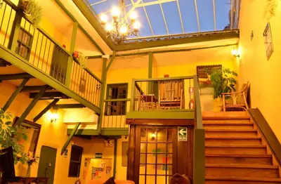 a large building with stairs and a glass ceiling at Hostal Mallqui in Cusco