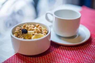 a bowl of cereal and a cup of coffee on a table at Amaru Colonial in Cusco