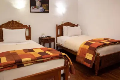 a hotel room with two beds in a room at Amaru Colonial in Cusco