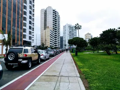 a line of cars parked on a street in a city at Miraflores Frente al Mar in Lima