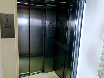 a elevator in a building with silver walls and floors at Miraflores Frente al Mar in Lima