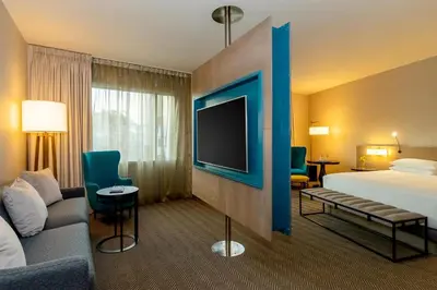 a hotel room with a bed and a flat screen tv at Hyatt Centric San Isidro Lima in Lima