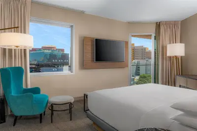 a hotel room with a bed and a chair and a tv at Hyatt Centric San Isidro Lima in Lima