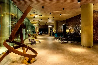 a lobby with chairs and tables in a building at Hyatt Centric San Isidro Lima in Lima