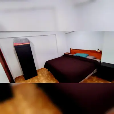 a bedroom with a bed and a night stand at Antarki Apartment in Cusco