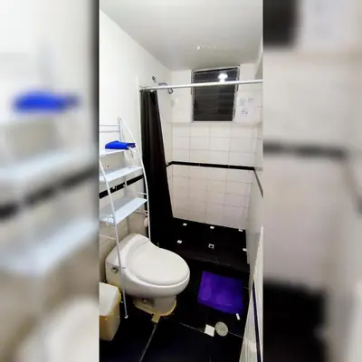 a small bathroom with a toilet and a shower at Antarki Apartment in Cusco