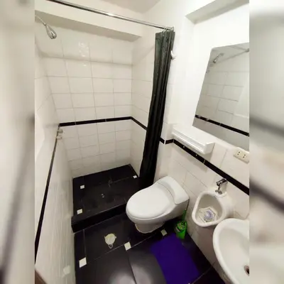 a small bathroom with a toilet and a sink at Antarki Apartment in Cusco