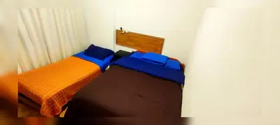 a bedroom with two beds with blue and orange at Antarki Apartment in Cusco