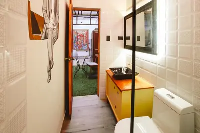 a bathroom with a toilet and a sink and a door at Casa Azul in Lima