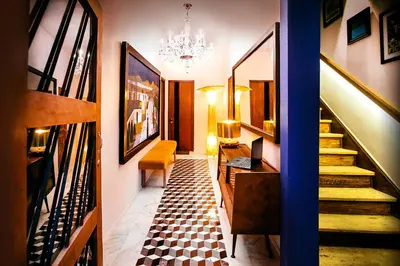 a hallway with a staircase and a chandelier at Casa Azul in Lima