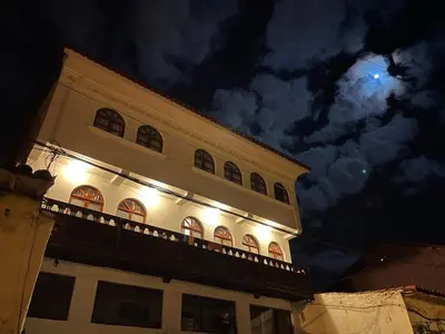 a building with lights on top of it at night at TATA Hotel Boutique in Cusco