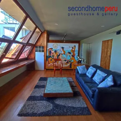 a living room with a couch and a table at Second Home Peru in Lima