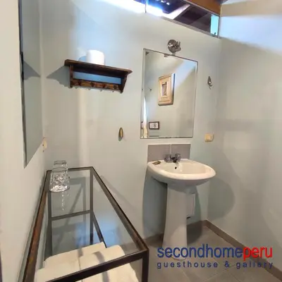 a bathroom with a sink and a mirror at Second Home Peru in Lima