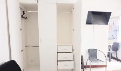 a living room with a mirror and a chair at In the heart of Lima in Lima