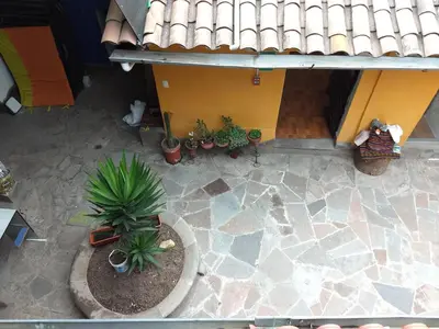 an overhead view of a patio with plants and a house at Chelitos Backpacker in Cusco