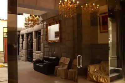 a living room with a couch and a mirror at Tinoco Apart Hotel in Ayacucho
