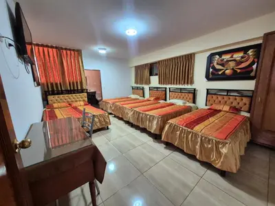 a hotel room with three beds in a room at Tinoco Apart Hotel in Ayacucho