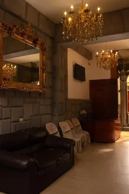 a living room with a couch and a mirror at Tinoco Apart Hotel in Ayacucho