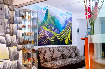 a living room with a couch in front of a painting at Peru Coca B&B Machupicchu in Machu Picchu