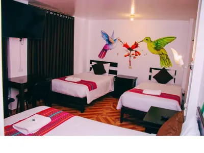 a bedroom with two beds with birds on the wall at Peru Coca B&B Machupicchu in Machu Picchu