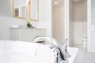 a white bathroom with a sink and a toilet at Casa Republica Barranco Boutique Hotel in Lima