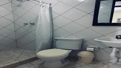 a bathroom with a toilet and a sink at Margarita's House Machupicchu in Machu Picchu