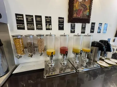 a counter with three glasses and a bunch of drinks at Awki´s Dream Hotel in Cusco