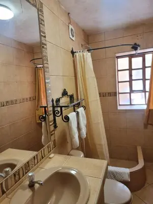 a bathroom with a sink and a shower at Departamentos Cusco in Cusco